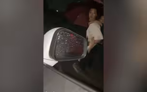感动！河南暴雨妈妈背着孩子在路上走 善良女司机冒险出手救助
